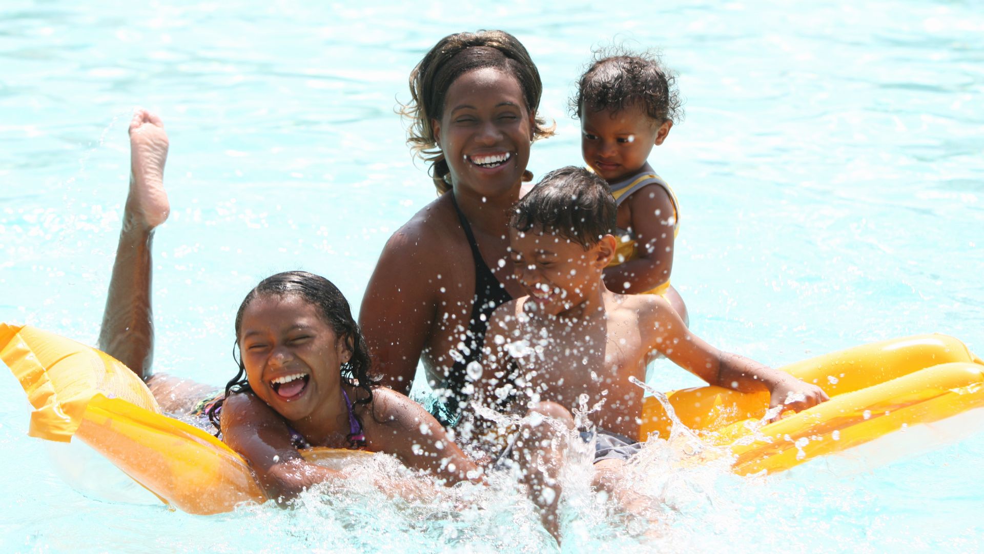 Family enjoying a bright swimming pool