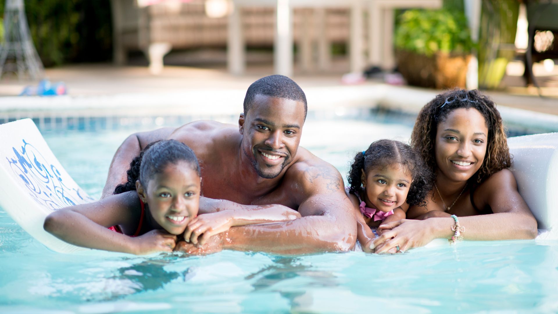 Family relaxing in a swimming pool